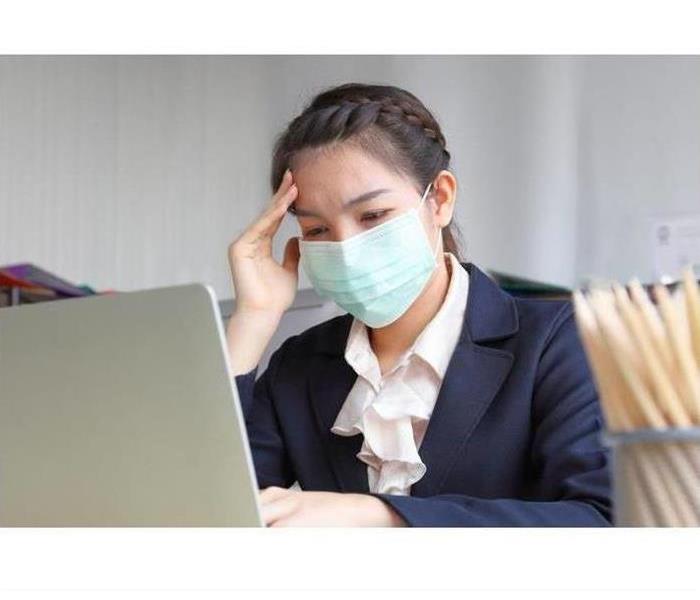Photo of Female with Mask working on her computer